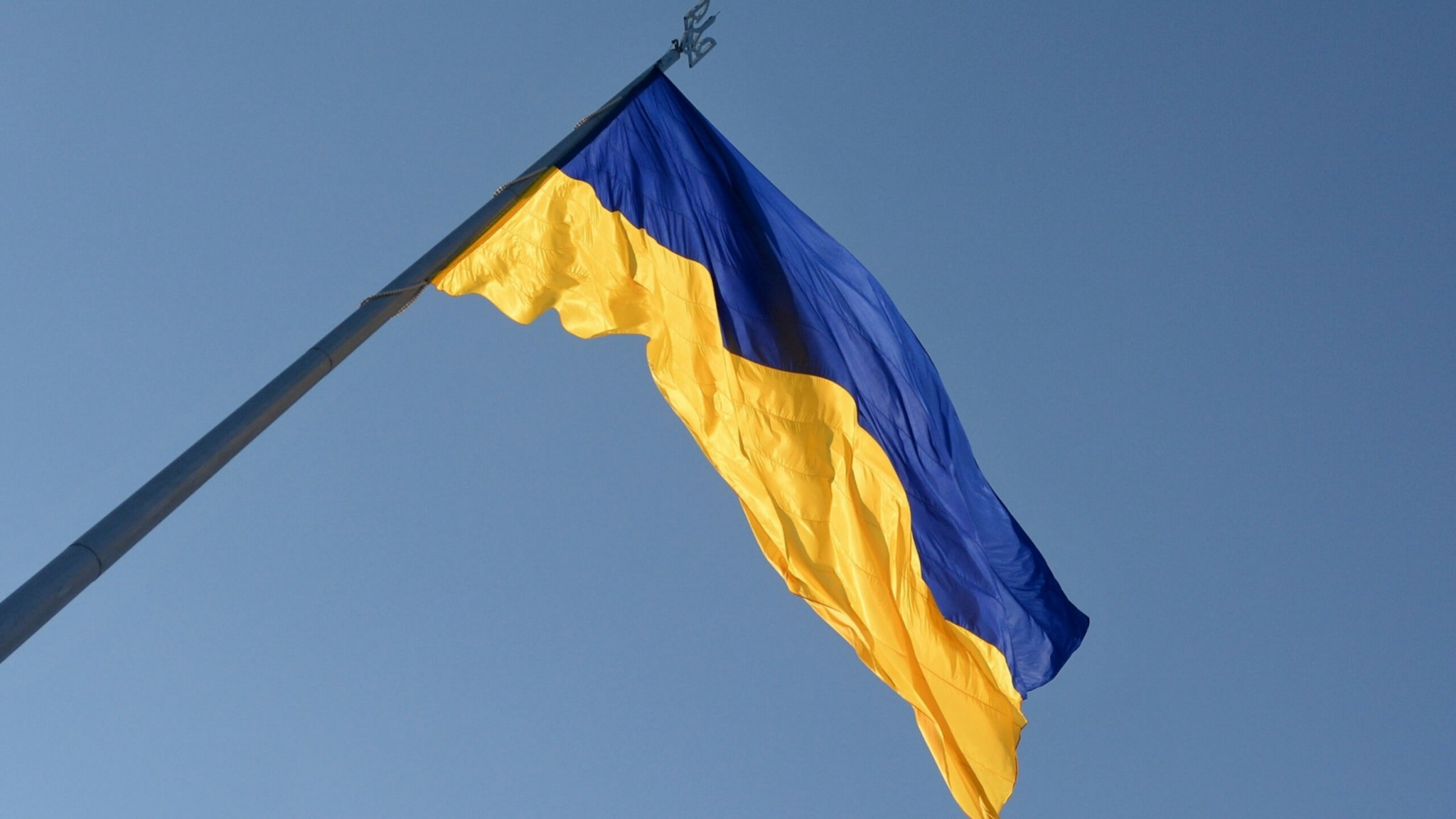 Ukraine's biggest flag flies some 90 metres above the city as it has been installed on the eve of the State Flag Day, with the Motherland Monument at centre in Kyiv.