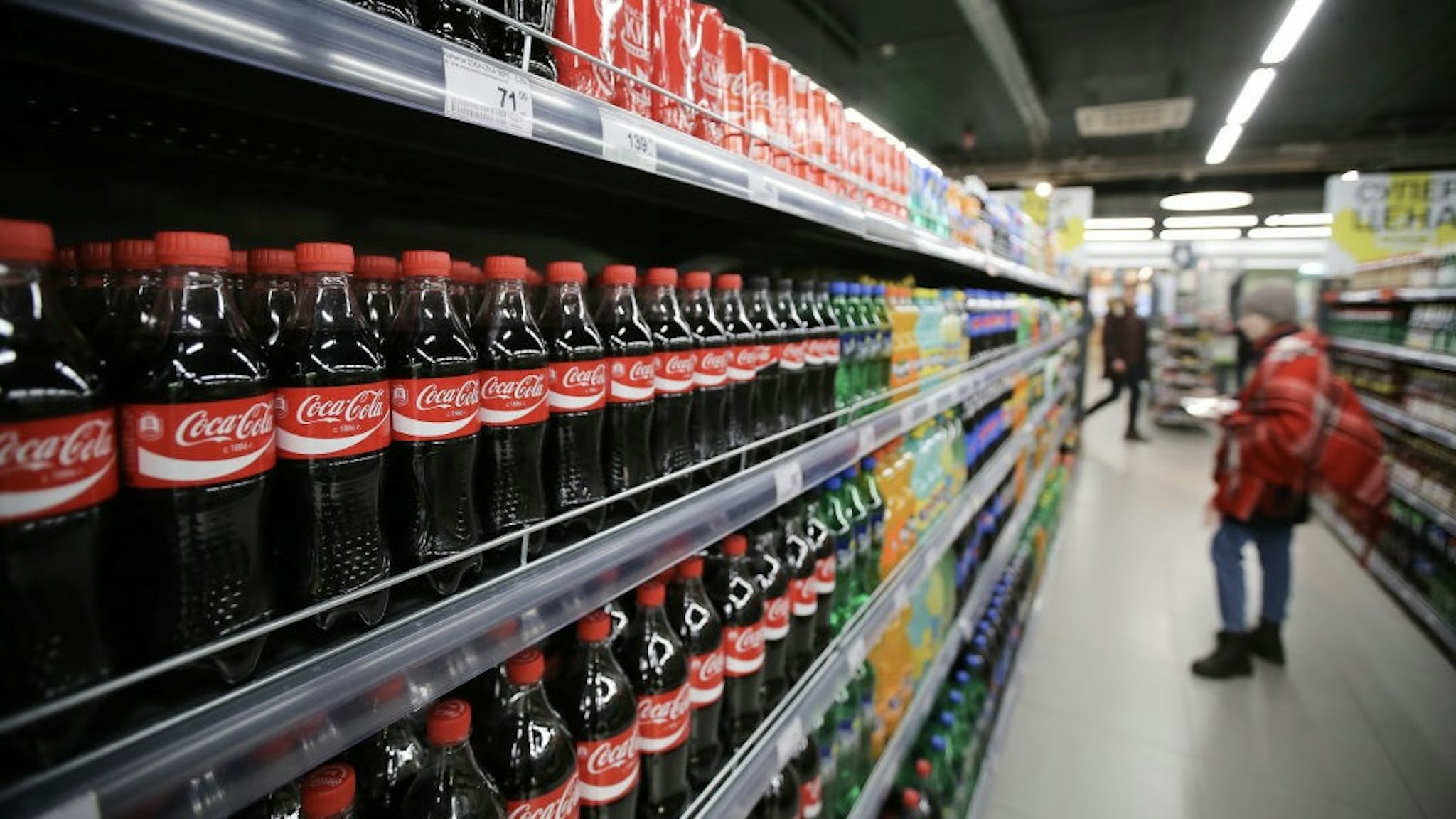 Retail Economy Inside An X5 Retail Group NV Supermarket As Russia Nears End Of Recession A customer browses a display of soft drinks including Coca-Cola Co. products inside a Perekrestok supermarket, operated by X5 Retail Group NV in Moscow, Russia, on Wednesday, Feb. 8, 2017. X5 says its interested in technologies for online payments in stores, personalized promotions based on big data and using robots in logistics. Photographer: Andrey Rudakov/Bloomberg via Getty Images Bloomberg / Contributor