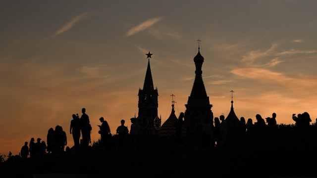 Football fans, tourists and The Kremlin is silhouetted at sunset during The World Cup tournament n June 15, 2018 in Moscow, Russia.