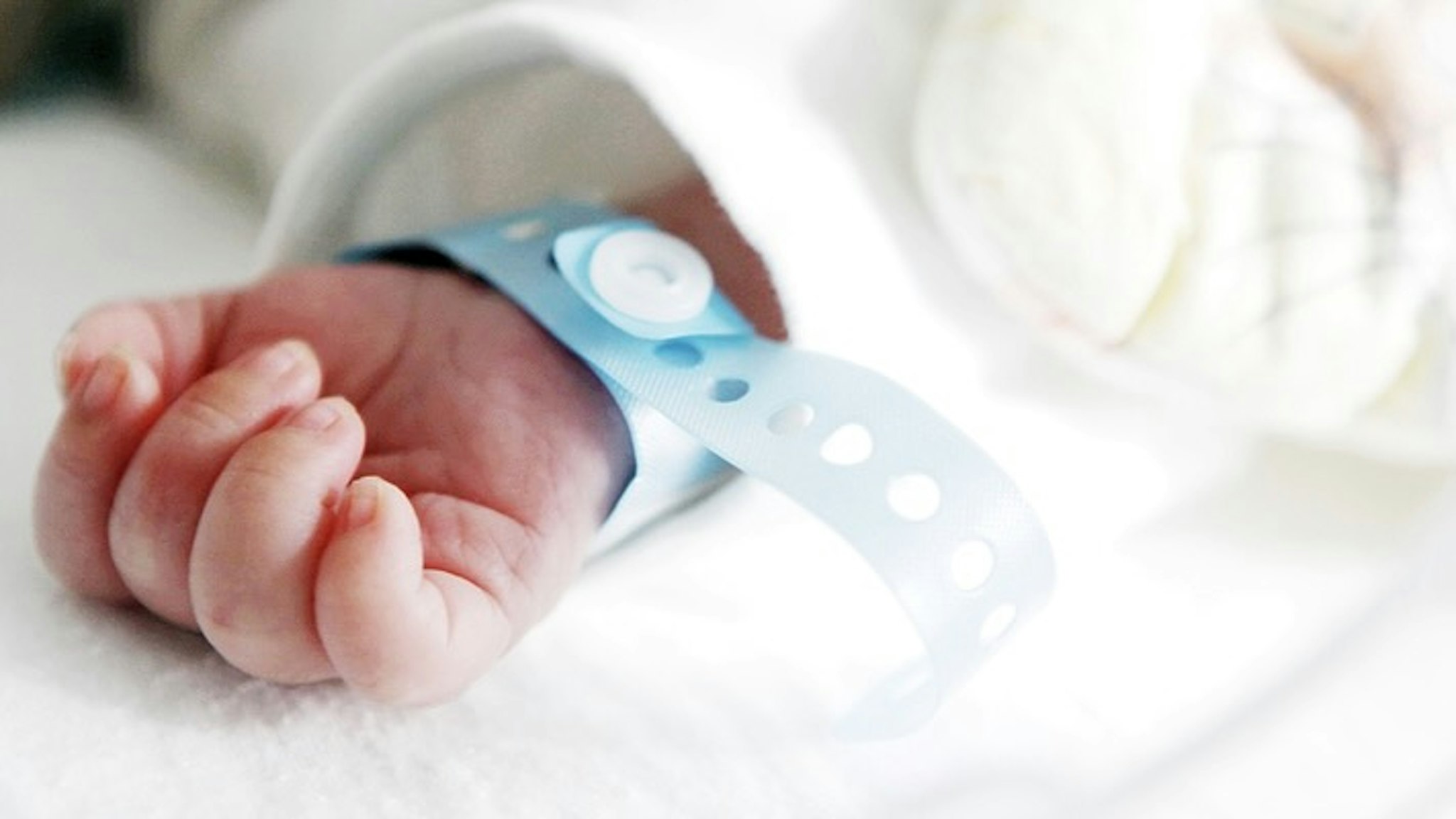 Cropped Hand Of Newborn Baby With Name Tag - stock photo Vladimir Nenov / EyeEm via Getty Images