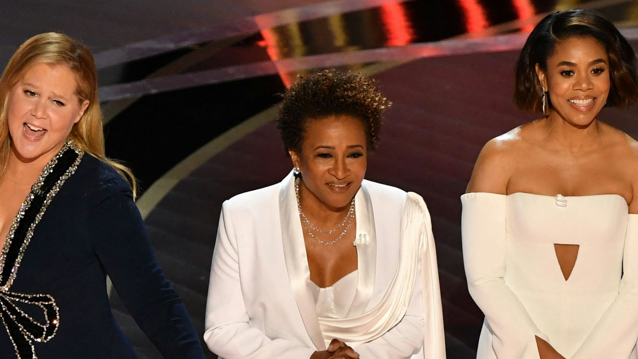 US actress and comedian Wanda Sykes (C) and US actress Regina Hall speak onstage during the 94th Oscars at the Dolby Theatre in Hollywood, California on March 27, 2022.