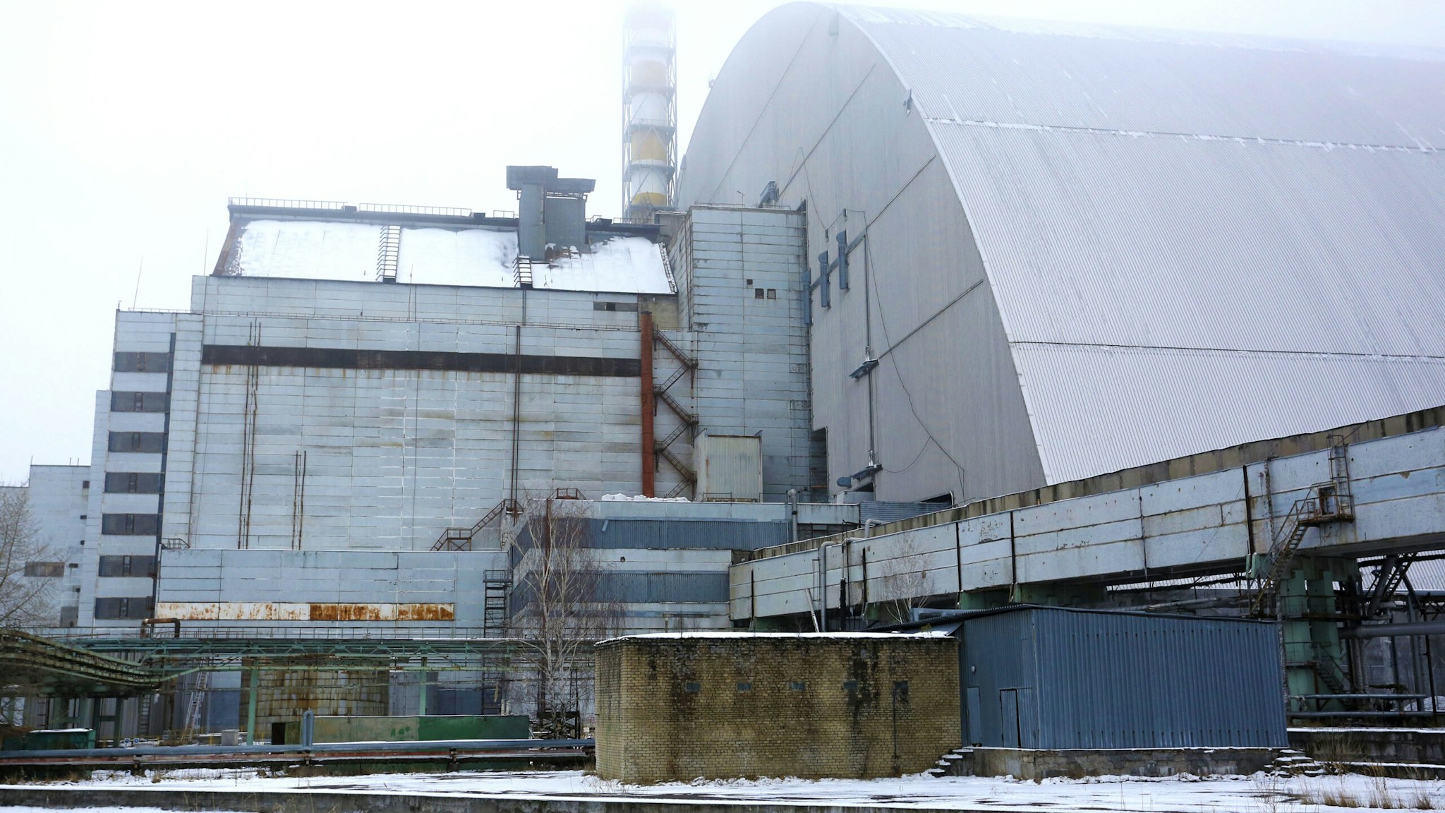 A worker stands next to the construction area of the Interim Spent Nuclear Fuel Dry Storage Facility (ISF-2) near the Chernobyl nuclear power plant, in Chernobyl, Ukraine, 22 December 2016. The new protective shelter over the remains of the nuclear reactor Unit 4 will secure the affected fourth reactor. The shelter is over 105 metres tall and weighs 36,000 tons. The explosion of Unit 4 of the Chernobyl nuclear power plant in the early hours of 26 April 1986 is still regarded the biggest accident in the history of nuclear power generation