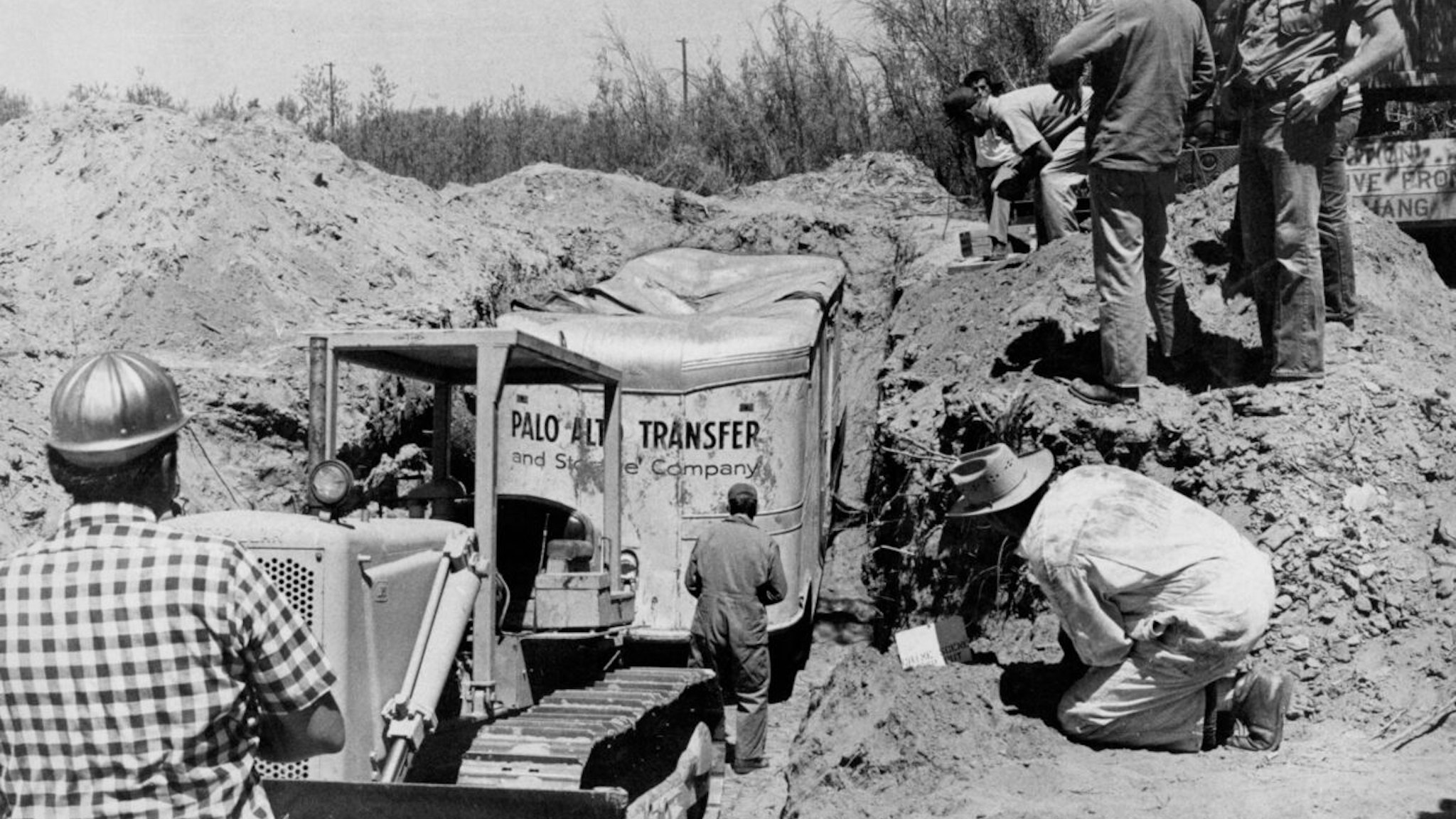Workers unearth the buried kidnap van in Livermore quarry. The weight of dirt crushed the top. Fresno Bee File Photo