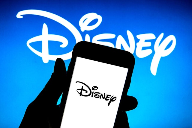 In this photo illustration a The Walt Disney Company logo seen displayed on a smartphone.