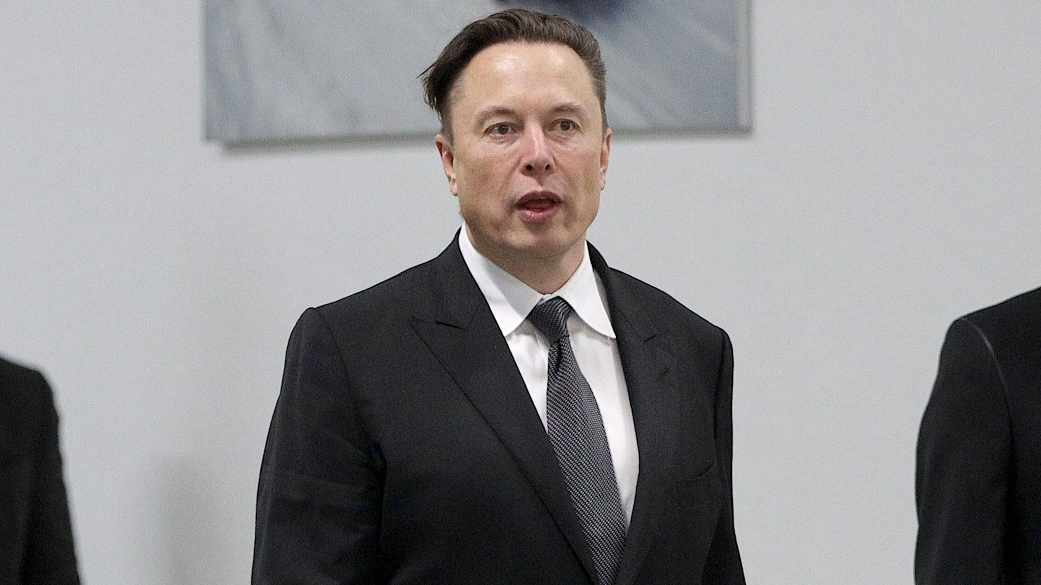 GRUENHEIDE, GERMANY - MARCH 22: Tesla CEO Elon Musk (R) arrives with German Chancellor Olaf Scholz during the official opening of the new Tesla electric car manufacturing plant on March 22, 2022 near Gruenheide, Germany. The new plant, officially called the Gigafactory Berlin-Brandenburg, is producing the Model Y as well as electric car batteries.