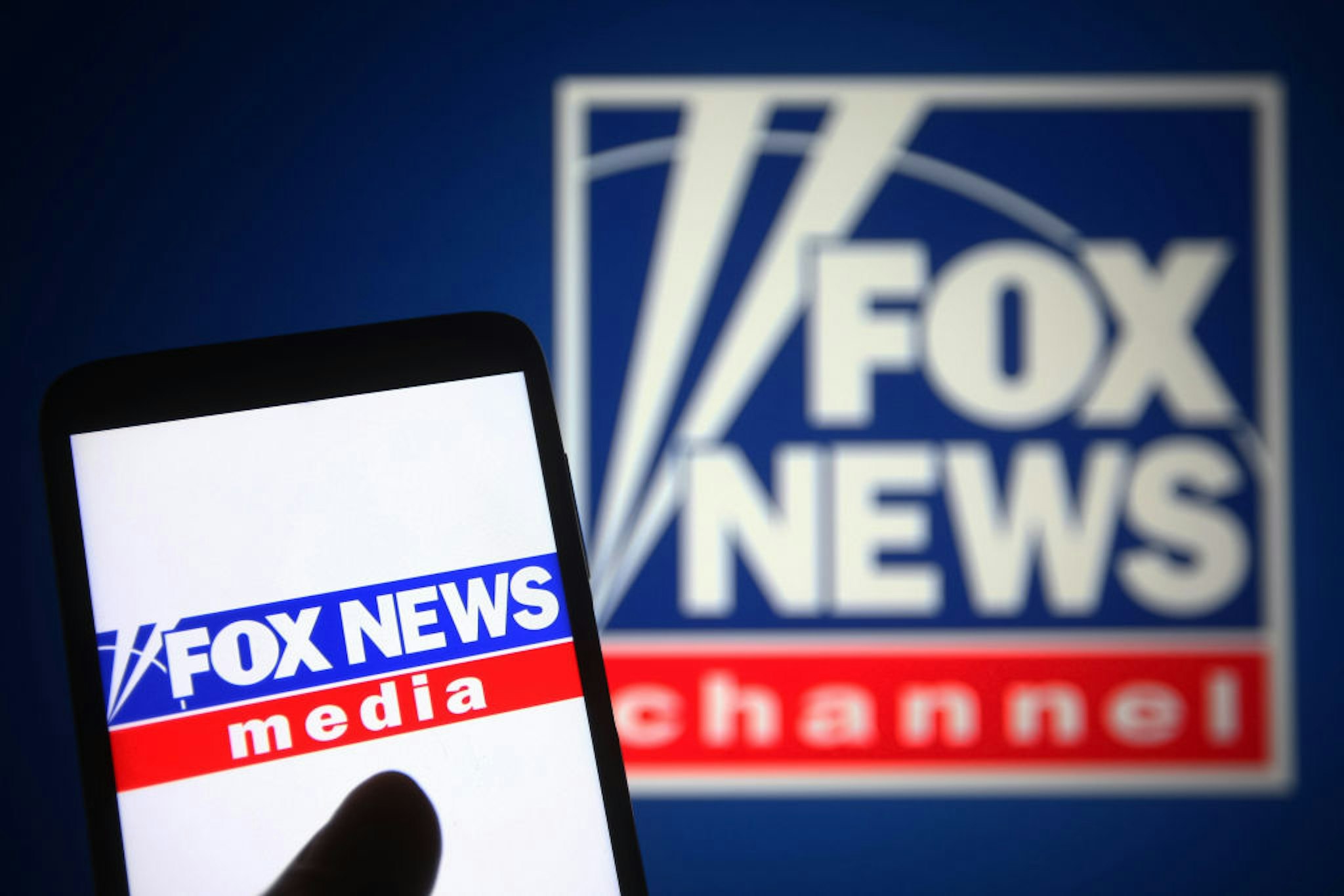 UKRAINE - 2021/09/21: In this photo illustration a Fox News Channel (FNC) logo is seen on a smartphone and a pc screen. (Photo Illustration by Pavlo Gonchar/SOPA Images/LightRocket via Getty Images)