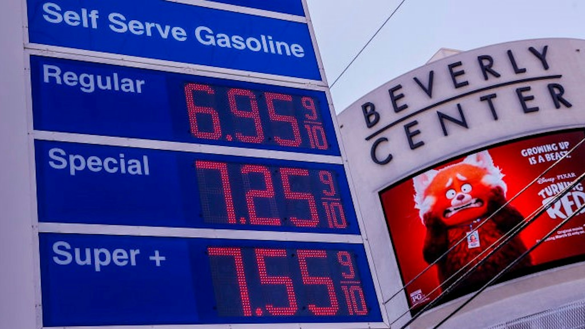 West Hollywood, CA, Tuesday, March 8, 2022 - The Mobil station at the corner of La Cienega and Beverly advertise prices higher than the norm throughout the Los Angeles area. Across the street is the Beverly Center where the Pixar movie Turning Red is advertised.