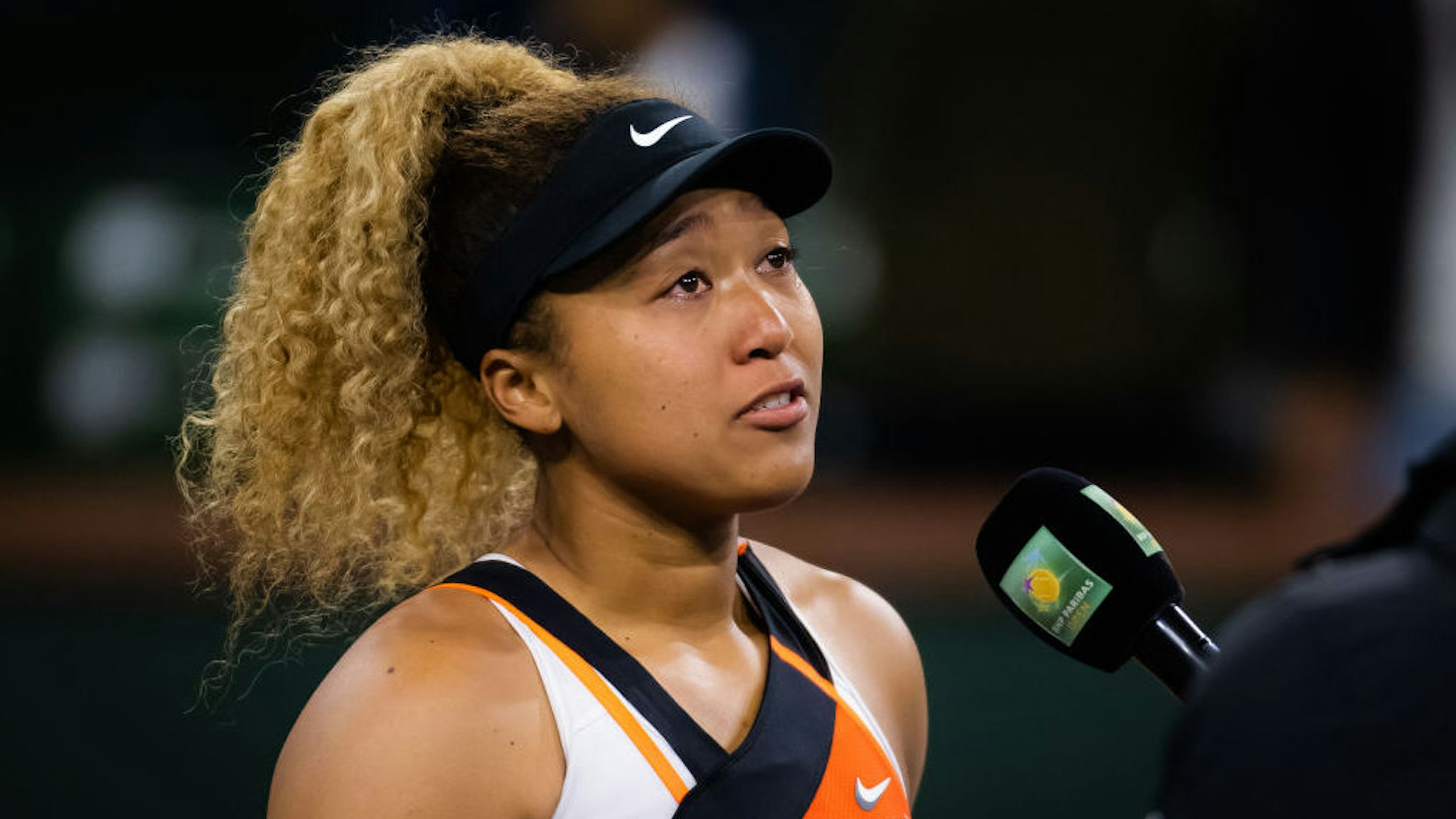 INDIAN WELLS, CALIFORNIA - MARCH 12: Naomi Osaka of Japan addresses the crowd after being heckled in her second-round match against Veronika Kudermetova of Russia at the 2022 BNP Paribas Open at the Indian Wells Tennis Garden on March 12, 2022 in Indian Wells, California (Photo by Robert Prange/Getty Images)