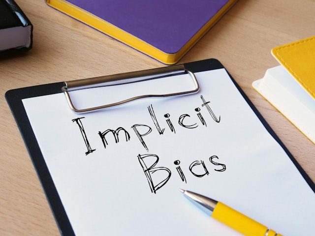 Implicit bias is shown on the conceptual photo using the text - stock photo