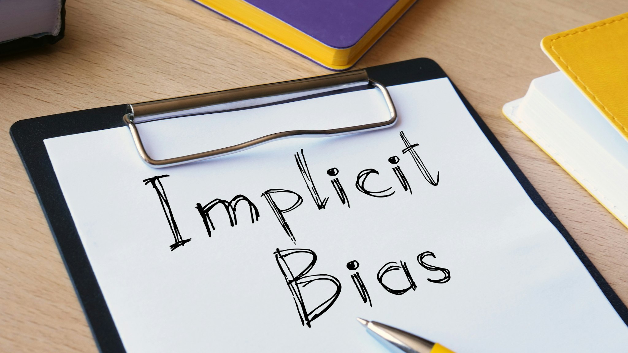 Implicit bias is shown on the conceptual photo using the text - stock photo