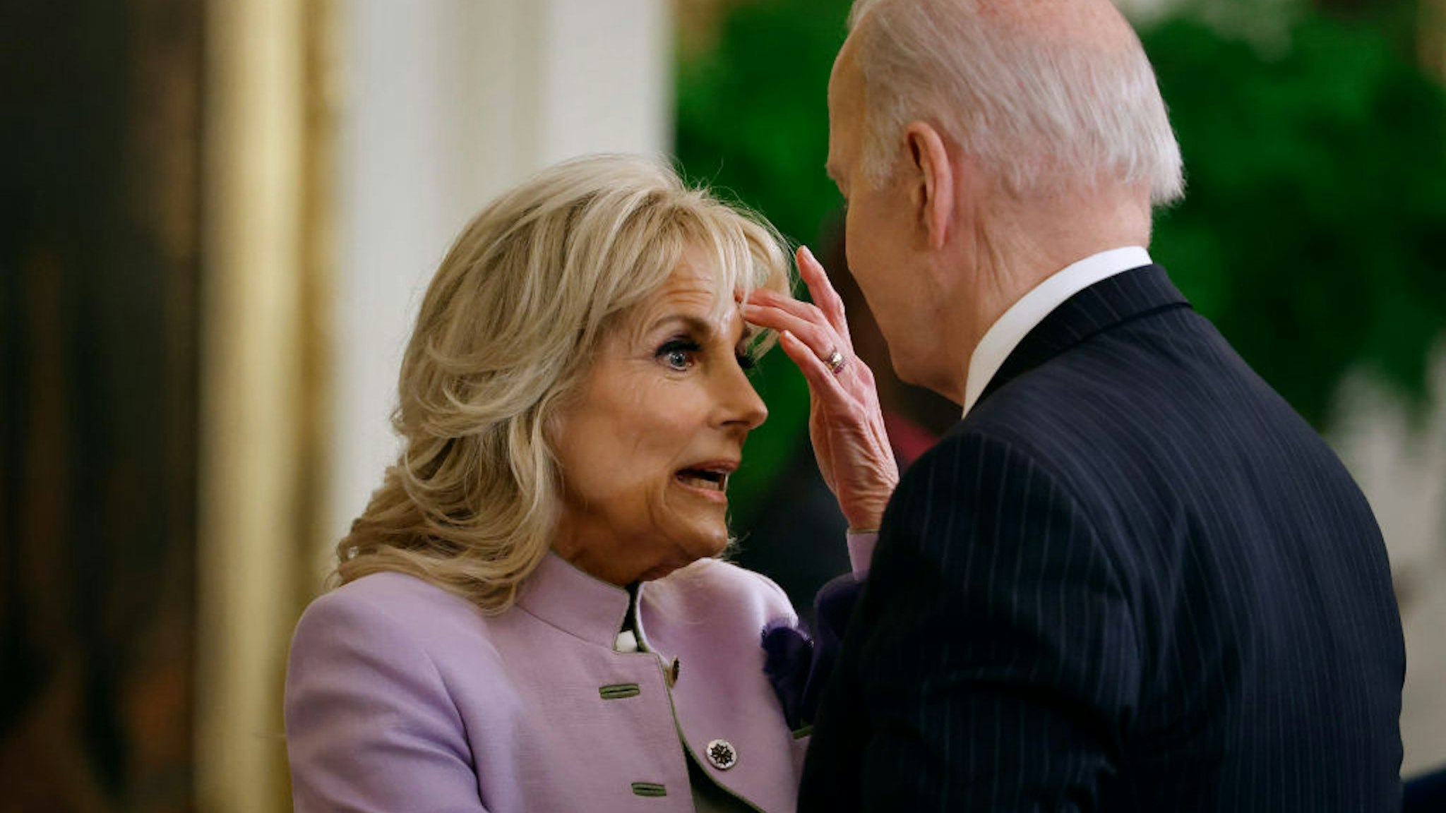 WASHINGTON, DC - MARCH 15: U.S. President Joe Biden (R) and first lady Jill Biden talk during an event celebrating Equal Pay Day in the East Room of the White House on March 15, 2022 in Washington, DC. Vice President Kamala Harris and her husband Doug Emhoff did not attend the event celebrating Women's History Month after Emhoff tested positive for COVID-19 earlier in the day. (Photo by Chip Somodevilla/Getty Images)