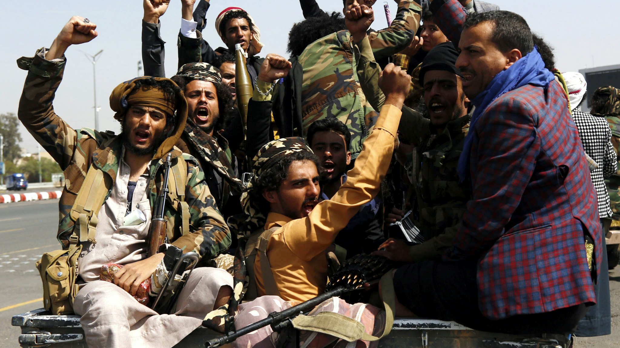 SANA'A, YEMEN - MARCH 17: Yemen's Houthi supporters chant slogans while riding a vehicle following their participation in a funeral of fighters killed during the ongoing battles between the Iran-allied Houthi movement fighters and forces of the ousted government backed by the coalition led by Saudi Arabia, on March 17, 2022 in Sana'a, Yemen. Yemen's Houthi movement said on Wednesday it would welcome and is ready for talks with the Saudi-led coalition and their Yemeni allies but in a neutral nation not in Riyadh as the Saudi-based Gulf Cooperation Council announced, as they consider the coalition as a part of this war.
