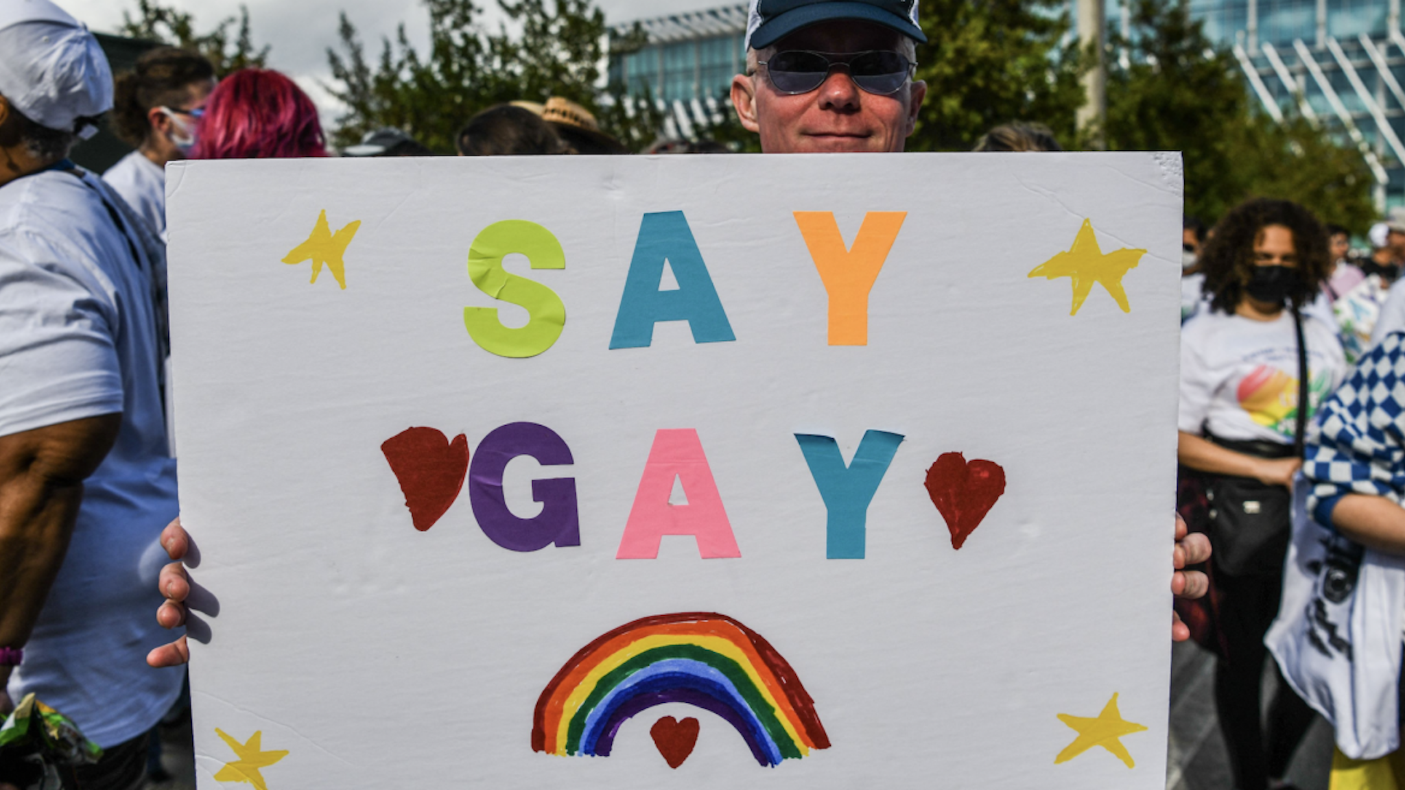 Members and supporters of the LGBTQ community attend the "Say Gay Anyway" rally in Miami Beach, Florida on March 13, 2022. - Florida's state senate on March 8 passed a controversial bill banning lessons on sexual orientation and gender identity in elementary schools, a step that critics complain will hurt the LGBTQ community. (Photo by CHANDAN KHANNA/AFP via Getty Images)