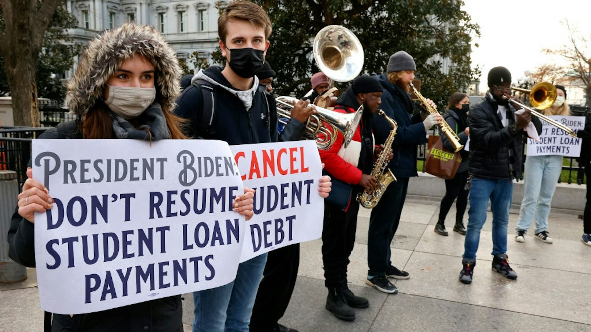 WASHINGTON, DC - DECEMBER 15: Activists and artists call on President Biden to not resume student loan payments in February and to cancel student debt near The White House on December 15, 2021 in Washington, DC.