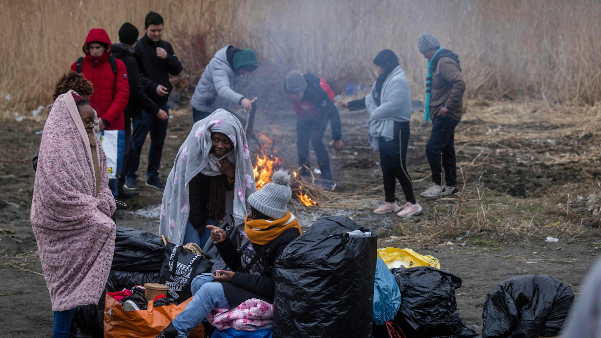 TOPSHOT - Refugees from many diffrent countries - from Africa, Middle East and India - mostly students of Ukrainian universities are seen at the Medyka pedestrian border crossing fleeing the conflict in Ukraine, in eastern Poland on February 27, 2022.