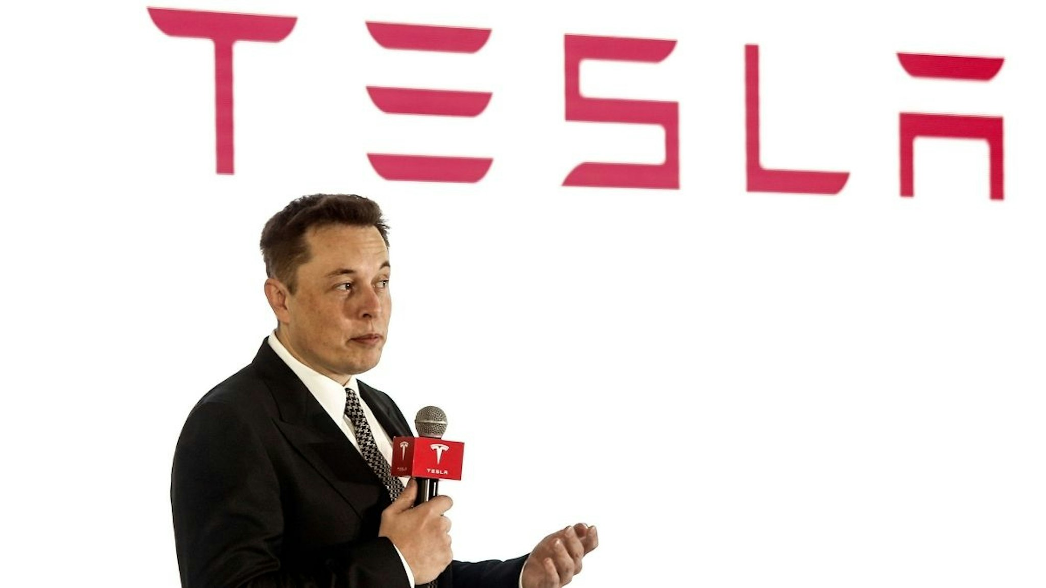 Elon Musk, Chairman, CEO and Product Architect of Tesla Motors, addresses a press conference to declare that the Tesla Motors releases v7.0 System in China on a limited basis for its Model S, which will enable self-driving features such as Autosteer for a select group of beta testers on October 23, 2015 in Beijing, China.