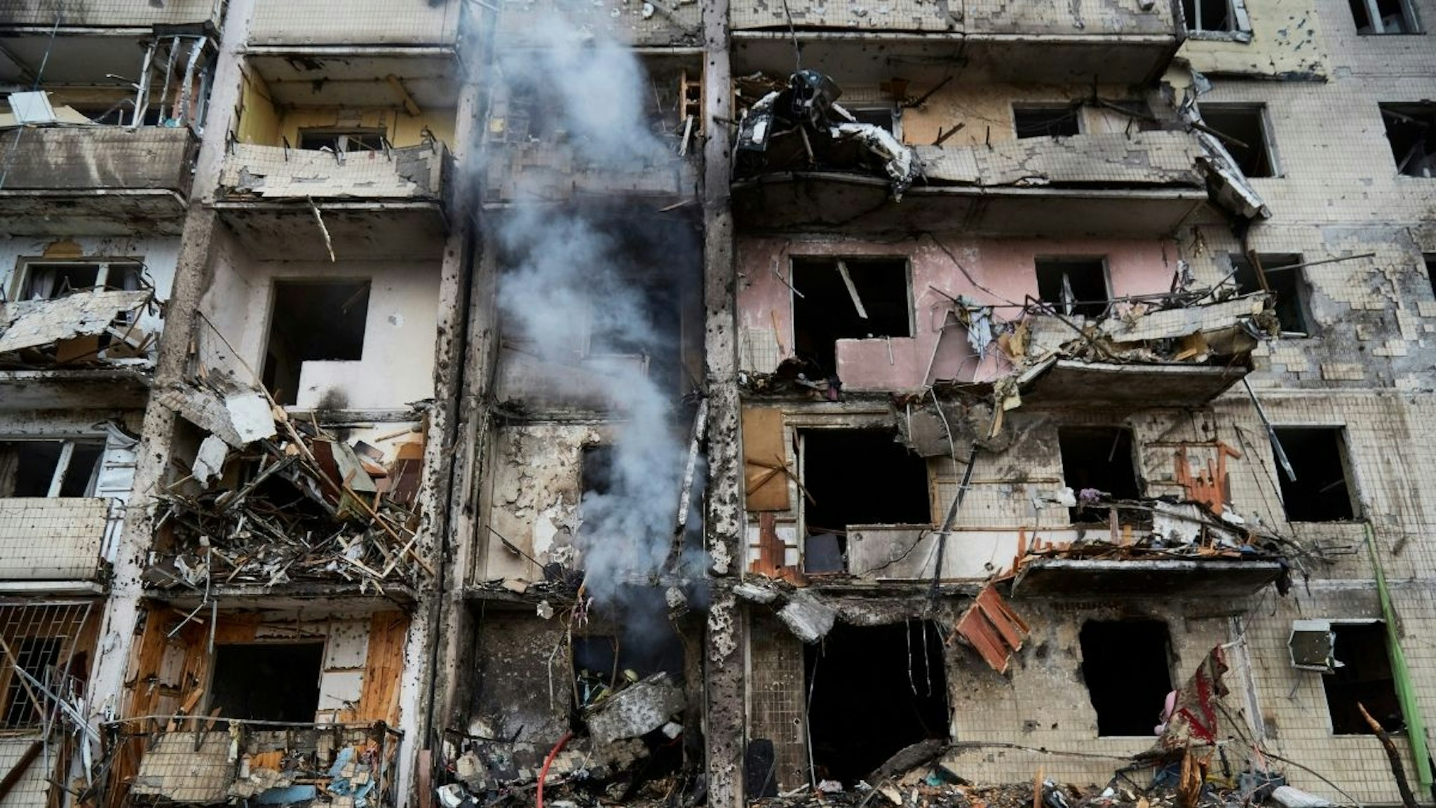 Firemen extinguish a fire inside a residential building that was hit by a missile on February 25, 2022 in Kyiv, Ukraine. Yesterday, Russia began a large-scale attack on Ukraine, with Russian troops invading the country from the north, east and south, accompanied by air strikes and shelling.
