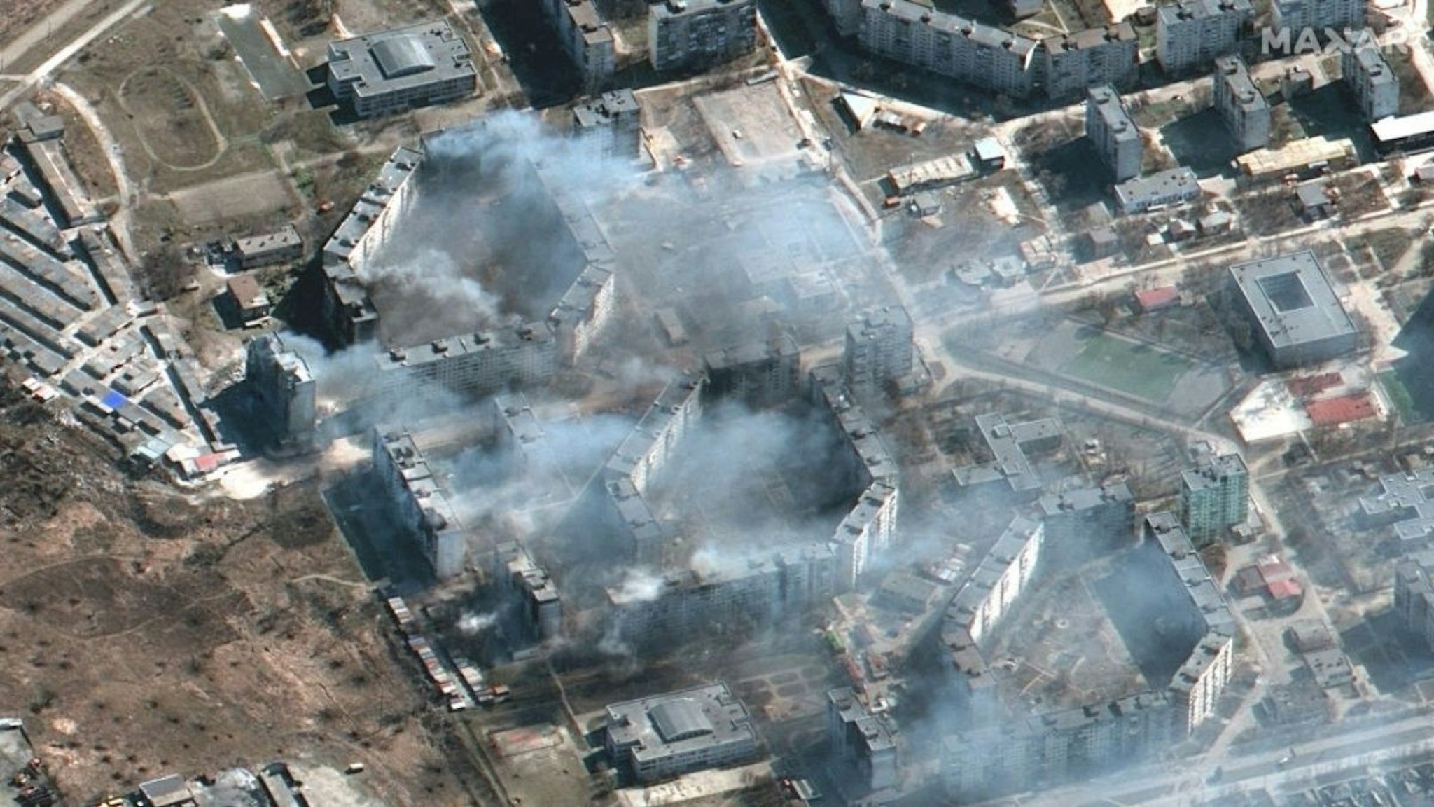 Maxar satellite imagery burning apartment buildings in northeastern Mariupol, Ukraine.