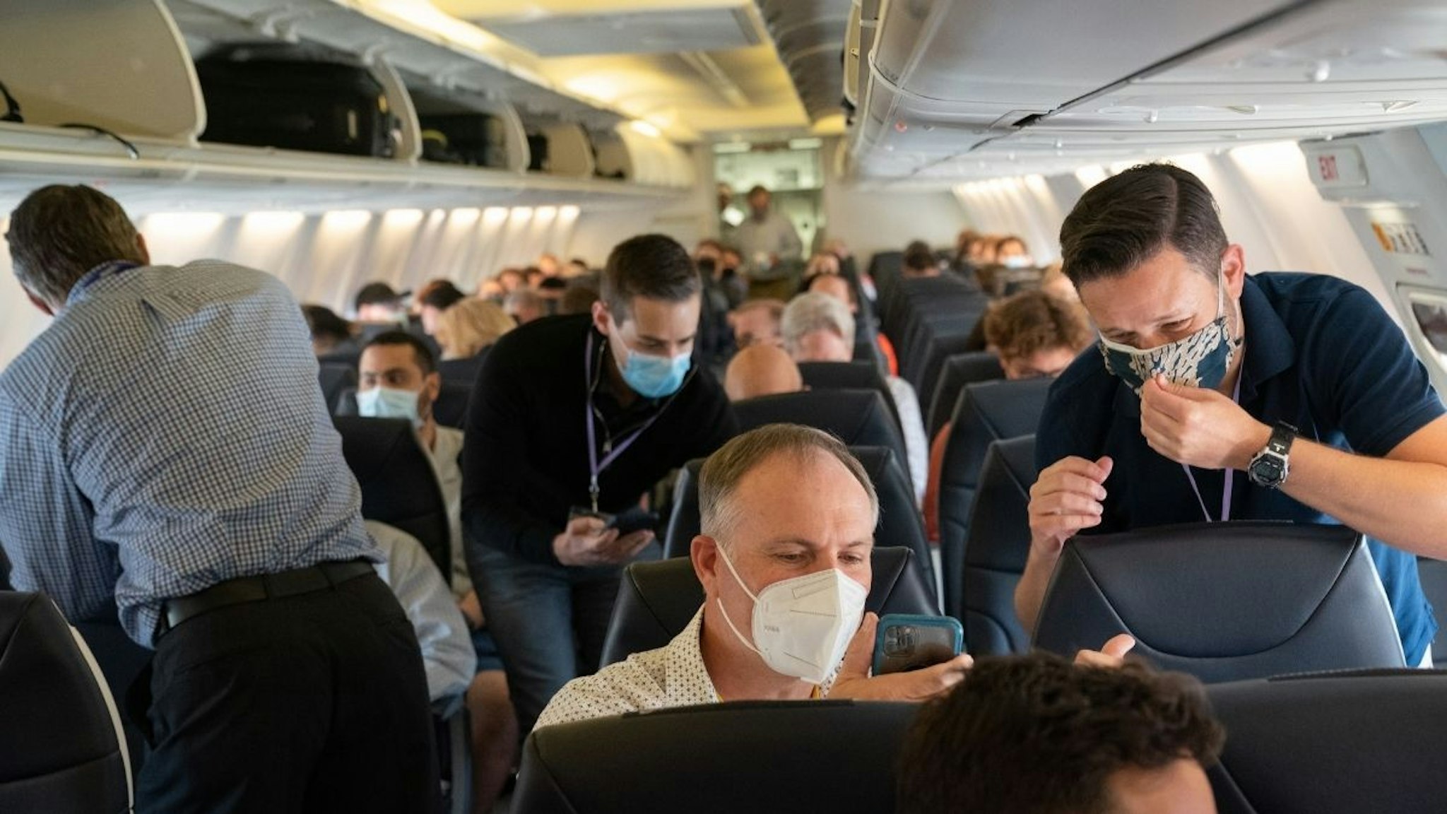 Passengers wearing protective masks onboard a Boeing Co. 737-800 operated by Avelo Airlines ahead of the airline's inaugural flight at Hollywood Burbank Airport (BUR) in Burbank, California, U.S., on Wednesday, April 28, 2021.