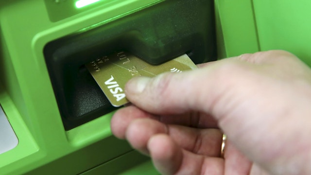 NOVOSIBIRSK, RUSSIA FEBRUARY 8, 2021: A customer uses an ATM machine in a branch of Sberbank amid the COVID-19 pandemic.