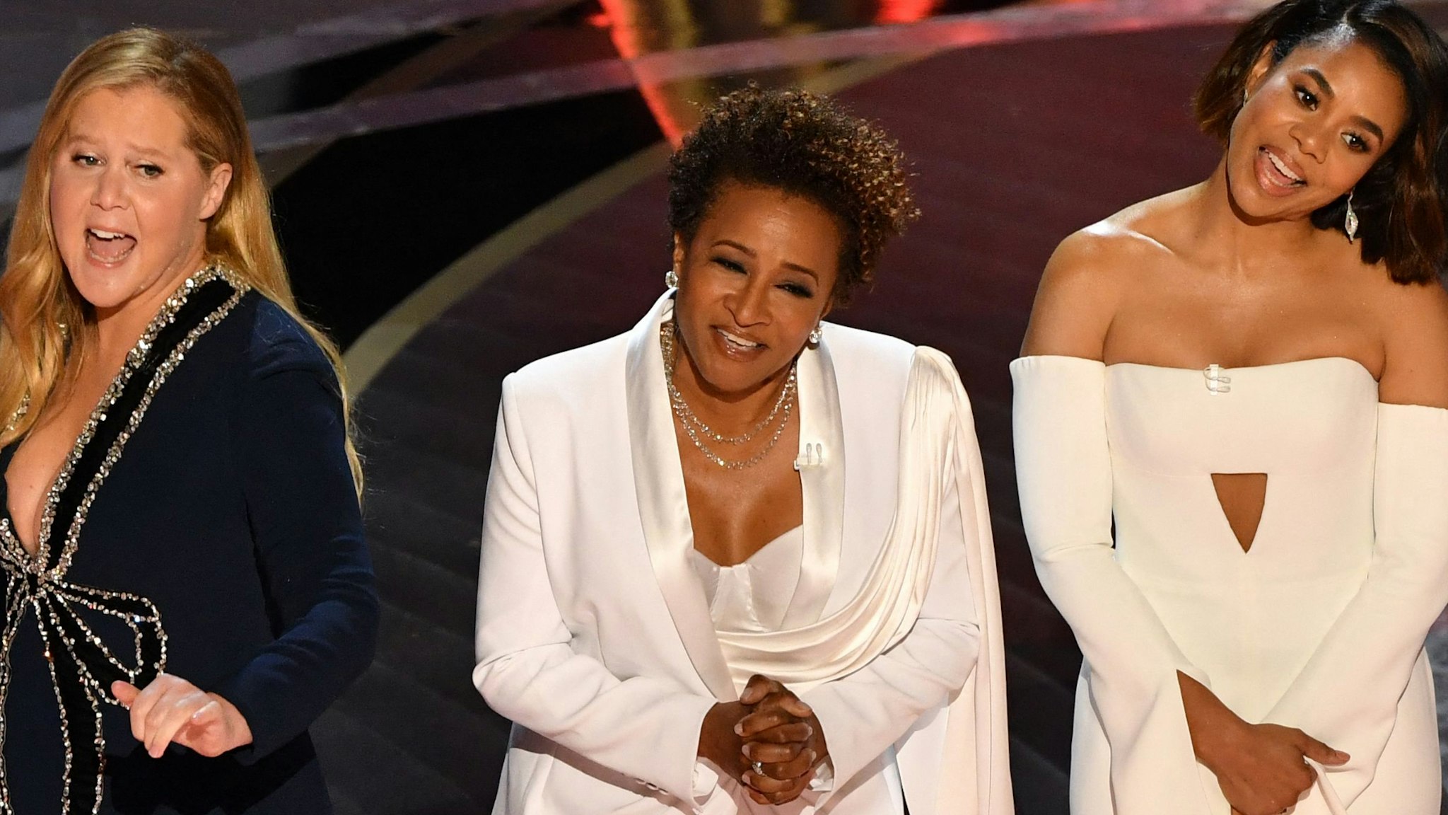 US actress and comedian Wanda Sykes (C) and US actress Regina Hall speak onstage during the 94th Oscars at the Dolby Theatre in Hollywood, California on March 27, 2022. (Photo by Robyn Beck / AFP)