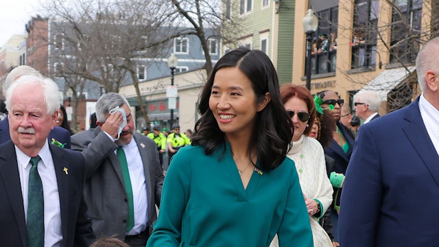 Boston - March 20: Boston Mayor Michelle Wu with her son, Cass Wu Pewarski, 4, Ed Flynn (Boston City Council president) and Mass Gov. Charlie Baker (back left) during the Bostons St. Patricks Day Parade in South Boston on March 20, 2022.
