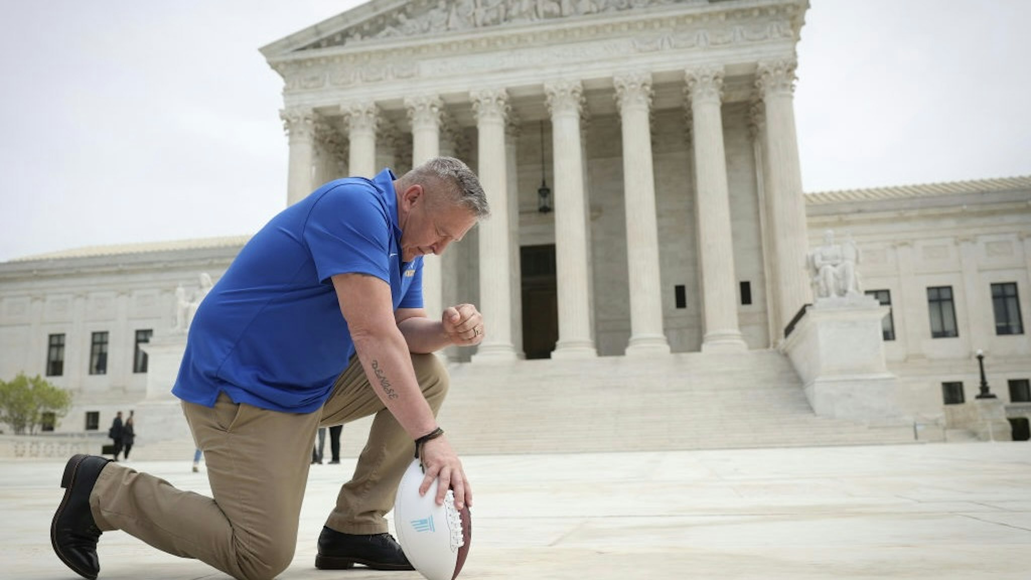 Christians Gather At Supreme Court To Pray As Bremerton Case Is Heard WASHINGTON, DC - APRIL 25: Former Bremerton High School assistant football coach Joe Kennedy takes a knee in front of the U.S. Supreme Court after his legal case, Kennedy vs. Bremerton School District, was argued before the court on April 25, 2022 in Washington, DC. Kennedy was terminated from his job by Bremerton public school officials in 2015 after refusing to stop his on-field prayers after football games. (Photo by Win McNamee/Getty Images) Win McNamee / Staff