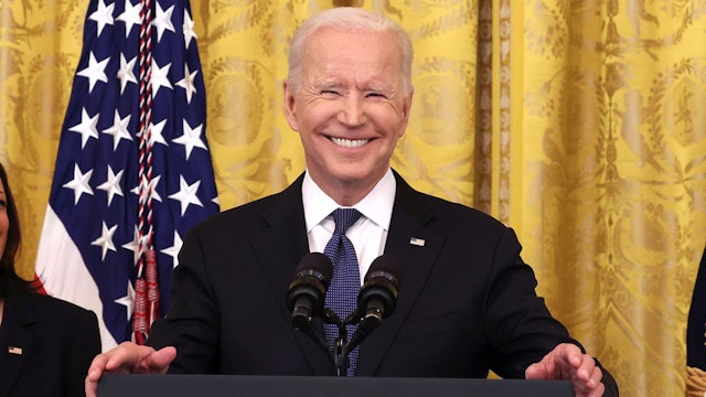 WASHINGTON, DC - MAY 20: U.S. President Joe Biden laughs while giving remarks, as Vice President Kamala Harris looks on, before a signing ceremony for the COVID-19 Hate Crimes Act in the East Room of the White House on May 20, 2021 in Washington, DC.  The legislation, drafted in response to the increased violence against the Asian American and Pacific Islander (AAPI) community during the Coronavirus pandemic, will create a new position in the Department of Justice to focus on the rise in hate crimes and provide resources to federal, state, and local jurisdictions to better report cases.