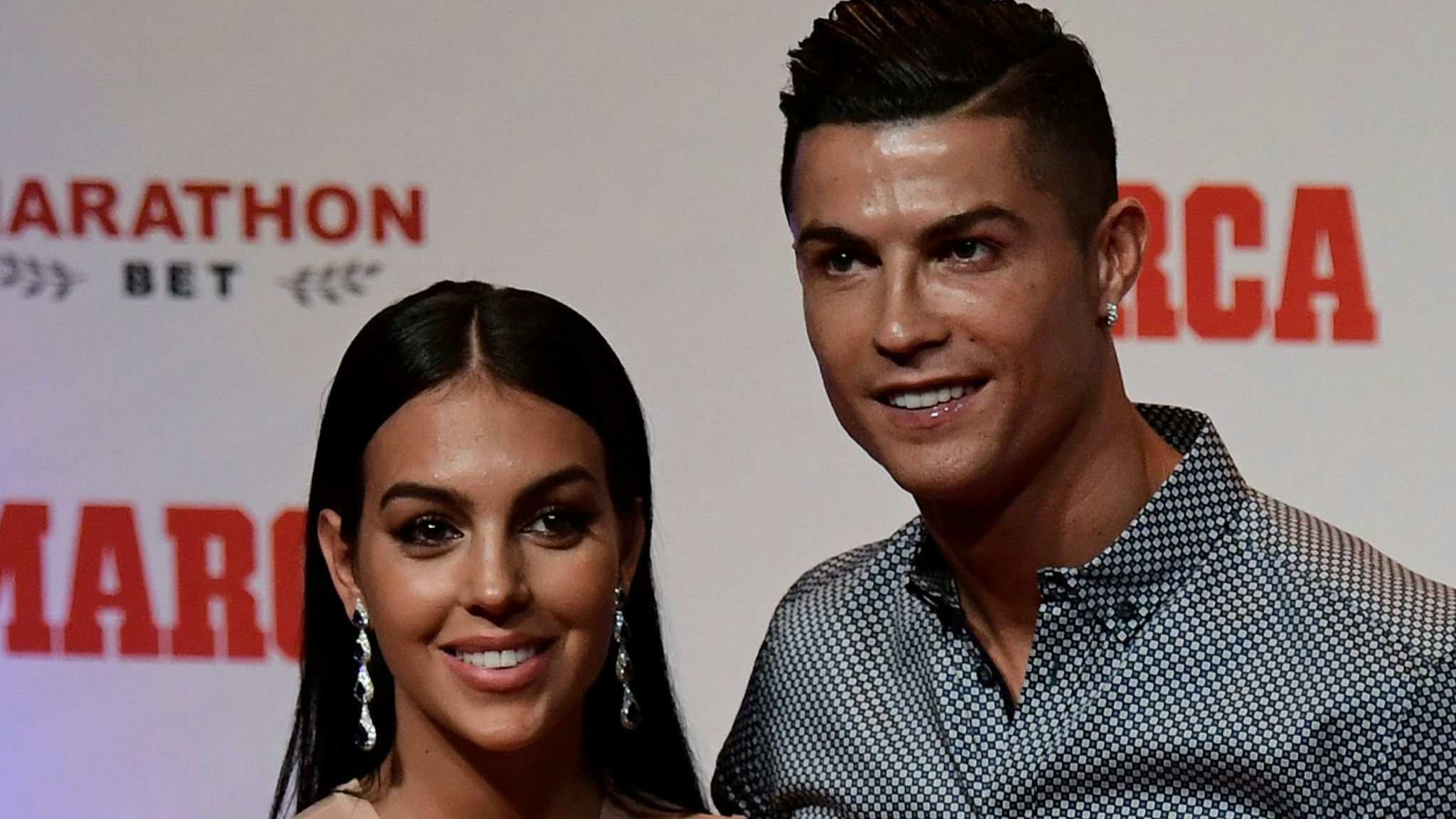 Portugal and Juventus forward Cristiano Ronaldo poses with his partner and Spanish model Georgina Rodriguez (L) after receiving the MARCA Leyenda (MARCA Legend) award in Madrid on July 29, 2019. - The award is attributed to sport professionals by the Spanish sports newspaper MARCA.