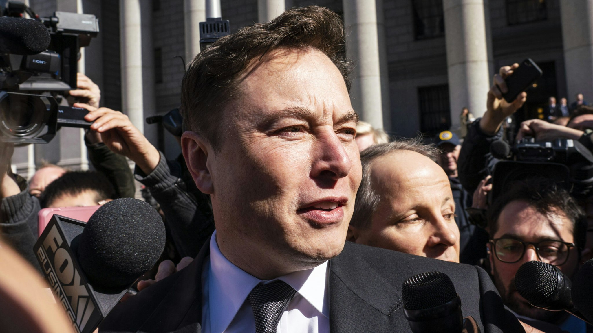 Elon Musk, chief executive officer of Tesla Inc., speaks to members of the media while departing from federal court in New York, U.S., on Thursday, April 4, 2019. U.S. District Judge Alison Nathan telegraphed her initial thoughts as the SEC and Elon Musk's lawyers presented their arguments over whether the Tesla Inc. CEO should be held in contempt for tweets the agency says violated an earlier agreement.