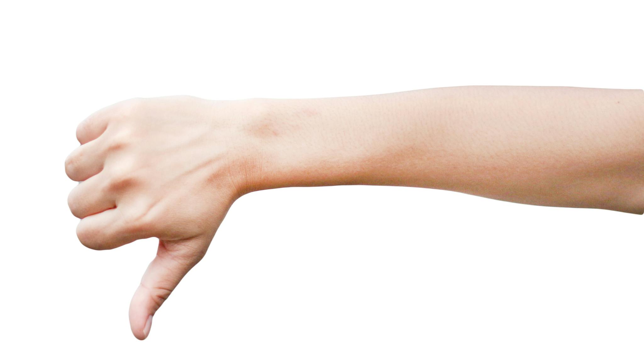 Close-Up Of Hand Sign Over White Background Thumb down