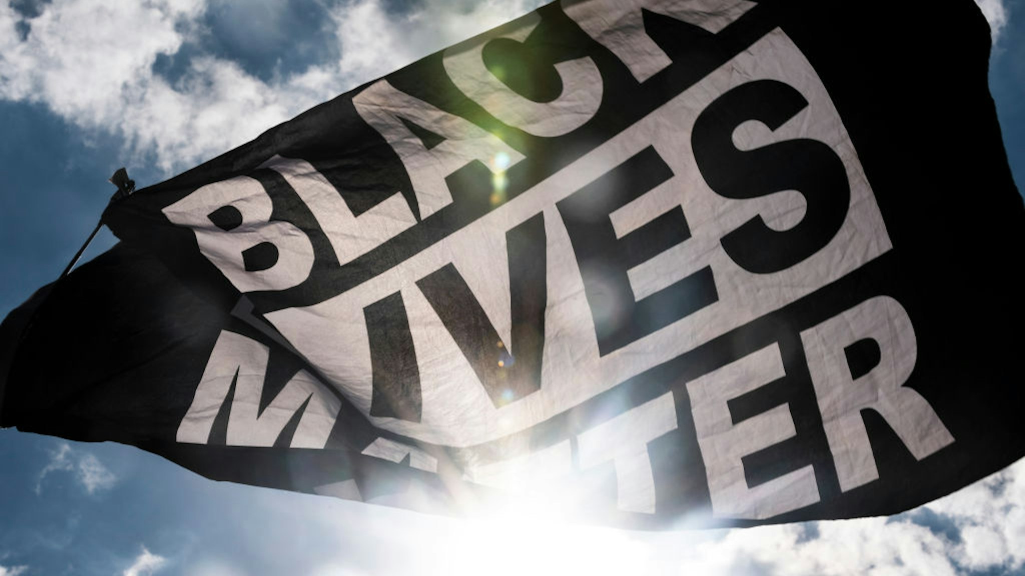 MINNEAPOLIS, MN - JUNE 13: A Black Lives Matter flag waves during a demonstration outside the First Police Precinct Station on June 13, 2020 in Minneapolis, Minnesota. Protests and demonstrations have continued in cities around the world in the wake of George Floyd's death in Minneapolis Police custody on May 25.