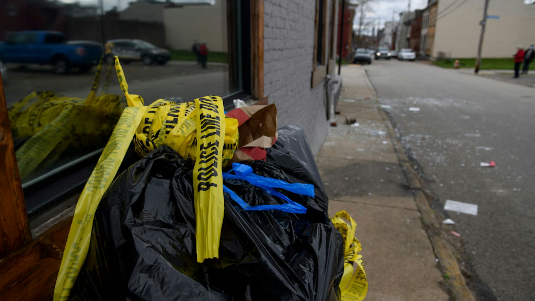 PITTSBURGH, PA - APRIL 17: Police tape, broken glass, and bloodstains outside an Airbnb apartment rental along Suismon Street on April 17, 2022 in Pittsburgh, Pennsylvania. Last night, a shooting at a house party at the rental left two people dead and nine injured. (Photo by Jeff Swensen/Getty Images)