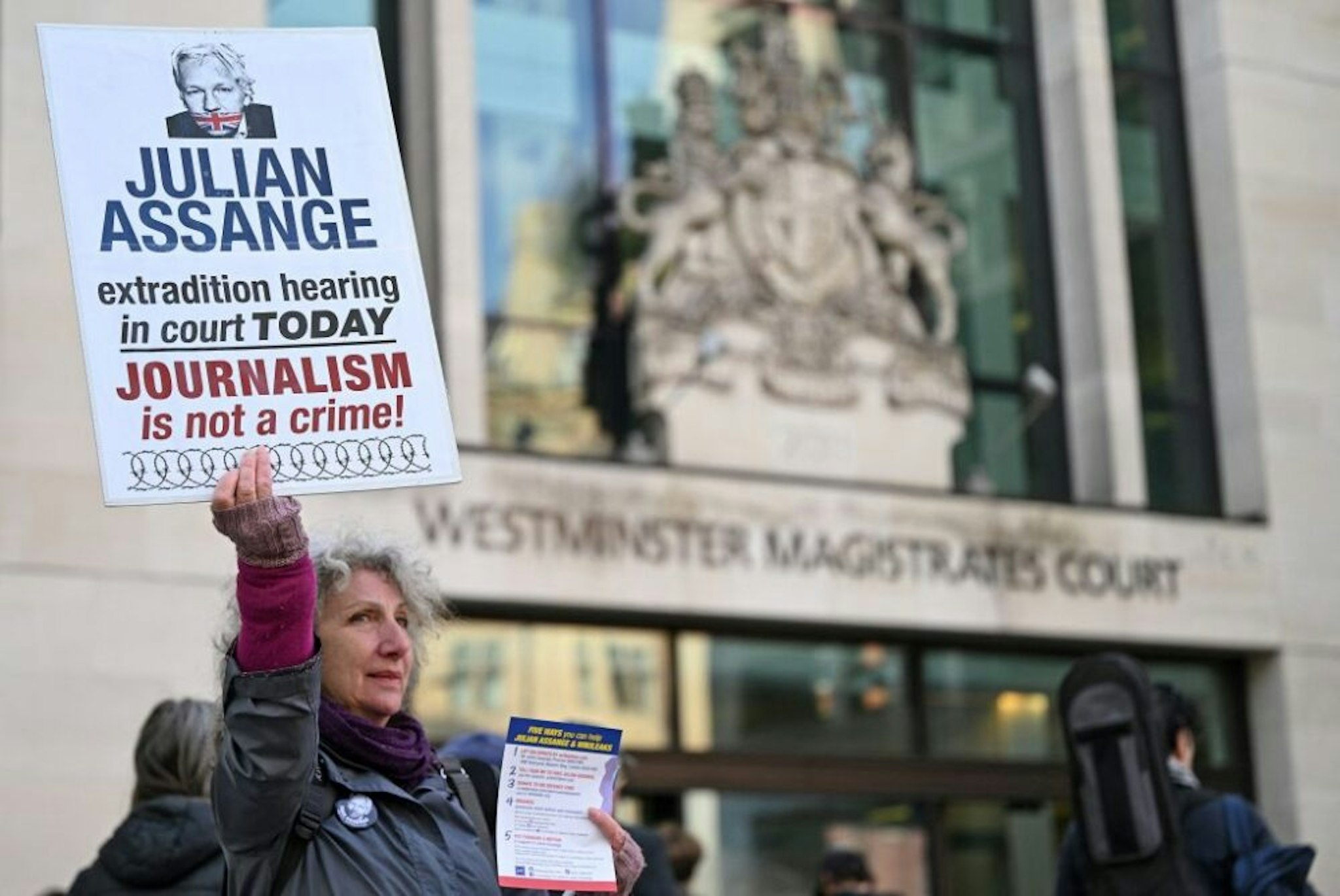 Supporters and activists hold placards outside Westminster Magistrates court in London on April 20, 2022, calling for WikiLeaks founder Julian Assange, who is currently in custody pending an extradition request from the US, to be freed. - Assange is set to at a British court on Wednesday for a hearing relating to Washington's extradition request over hacking charges in a test case of media freedoms in the digital age and the global limits of US justice.