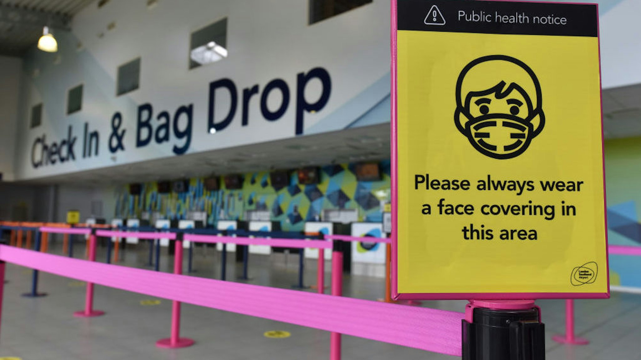 A general view of public health notice warning that face coverings should always be worn in the Check in and bag drop area as London Southend airport prepares for the reintroduction of passenger flights on June 18, 2020 in Southend-on-Sea, England.