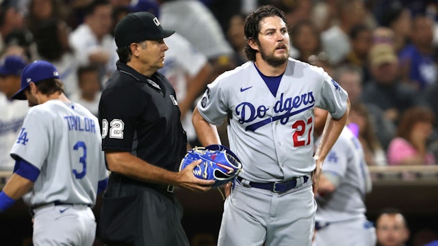 SAN DIEGO, CALIFORNIA - JUNE 23: Homeplate umpire James Hoye #92 checks the glove of Trevor Bauer #27 of the Los Angeles Dodgers during the fourth inning of a game against the Los Angeles Dodgers at PETCO Park on June 23, 2021 in San Diego, California. (Photo by Sean M. Haffey/Getty Images)