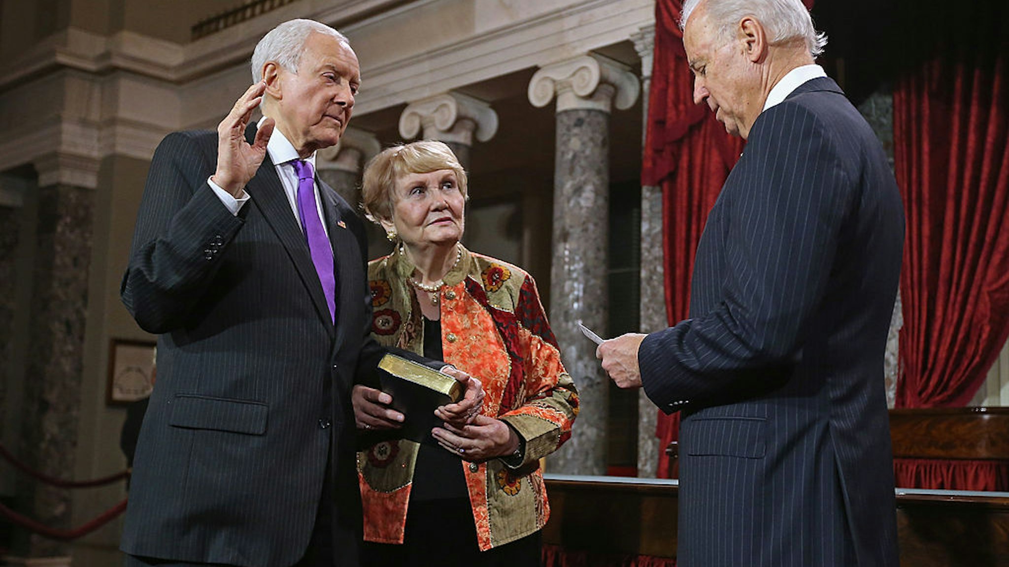 WASHINGTON, DC - JANUARY 03: U.S. Sen. Orrin Hatch (R-UT) (L) participates in a reenacted swearing-in with his wife Elaine Hatch and U.S. Vice President Joe Biden in the Old Senate Chamber at the U.S. Capitol January 3, 2013 in Washington, DC. Biden swore in the newly-elected and re-elected senators earlier in the day on the floor of the current Senate chamber. (Photo by Chip Somodevilla/Getty Images)