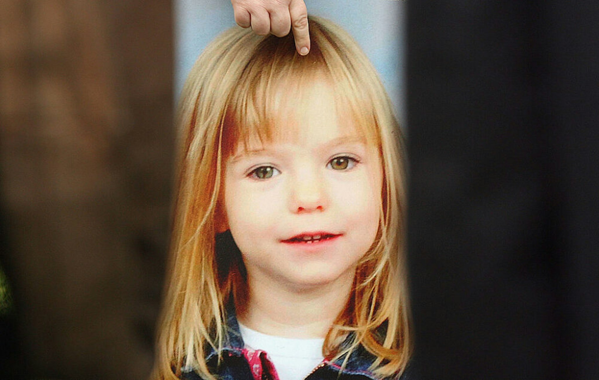 LONDON - MAY 16: A picture of missing toddler Madeleine McCann is held by her aunt Philomena McCann as she gives television interviews after visiting Parliament on May 16, 2007 in London. Madeleine McCann disappeared from a holiday complex in Praia da Luz, Portugal 13 days ago.