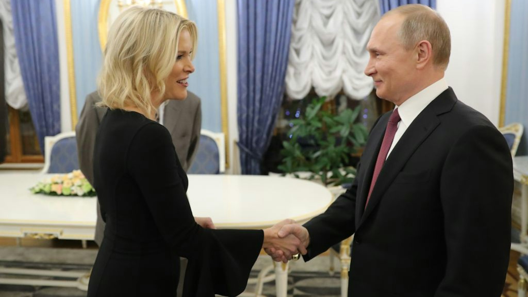 Russia's President Vladimir Putin (R) shakes hands with US NBC news network anchor Megyn Kelly prior to an interview at the Kremlin on March 1, 2018 in Moscow. (Photo by Mikhail KLIMENTYEV / SPUTNIK / AFP) (Photo credit should read MIKHAIL KLIMENTYEV/AFP via Getty Images)