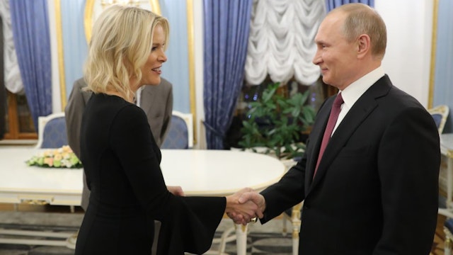 Russia's President Vladimir Putin (R) shakes hands with US NBC news network anchor Megyn Kelly prior to an interview at the Kremlin on March 1, 2018 in Moscow. (Photo by Mikhail KLIMENTYEV / SPUTNIK / AFP) (Photo credit should read MIKHAIL KLIMENTYEV/AFP via Getty Images)