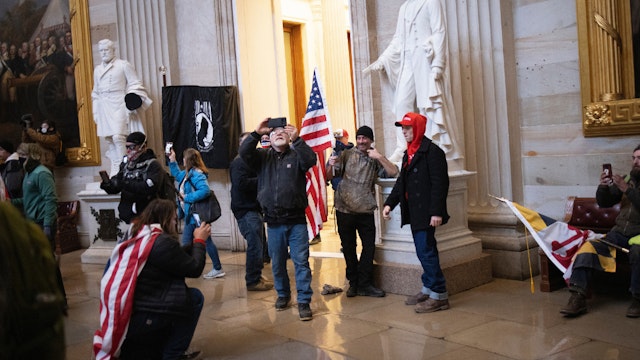 WASHINGTON, DC - JANUARY 06: Protesters supporting U.S. President Donald Trump gather gather in the Rotunda of the U.S. Capitol after groups breached the building's security on January 06, 2021 in Washington, DC.