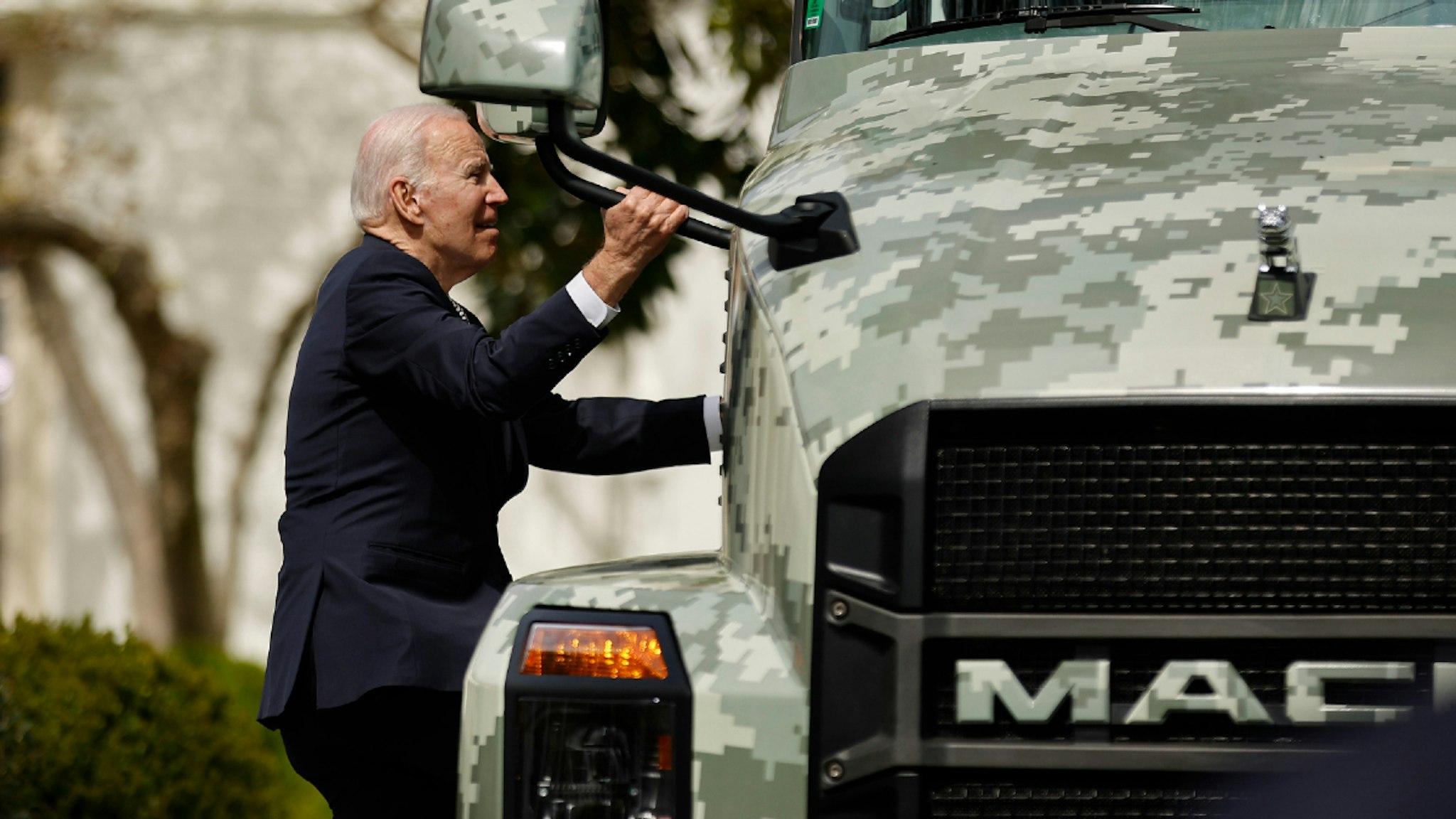 WASHINGTON, DC - APRIL 04: U.S. President Joe Biden climbs onto a semi truck at the conclusion of an event highlighting his 'Trucking Action Plan' on the South Lawn of the White House on April 04, 2022 in Washington, DC.