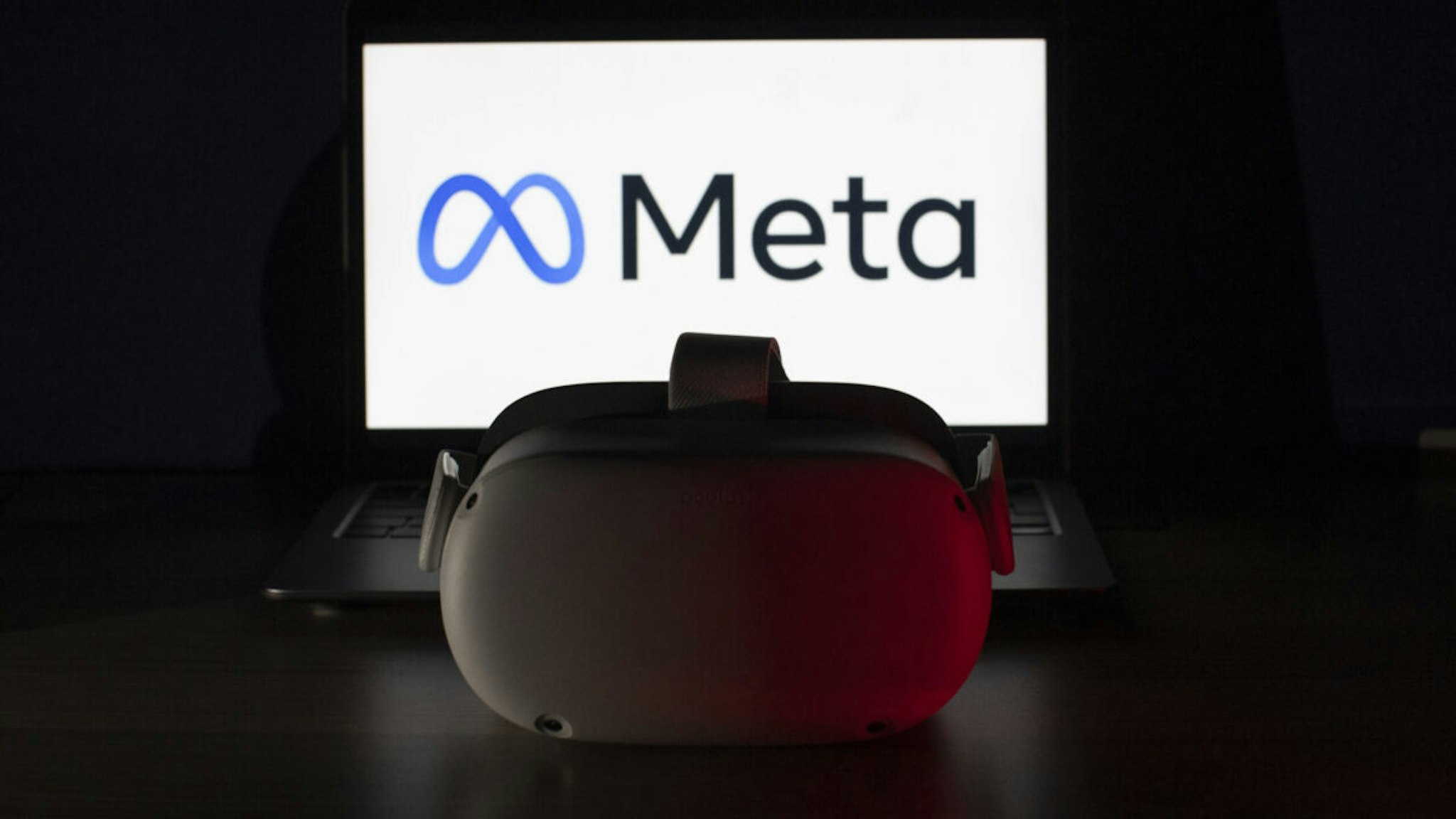 In this photo illustration the logo of "Meta" is displayed behind the VR headset in Ankara, Turkiye on April 1, 2022