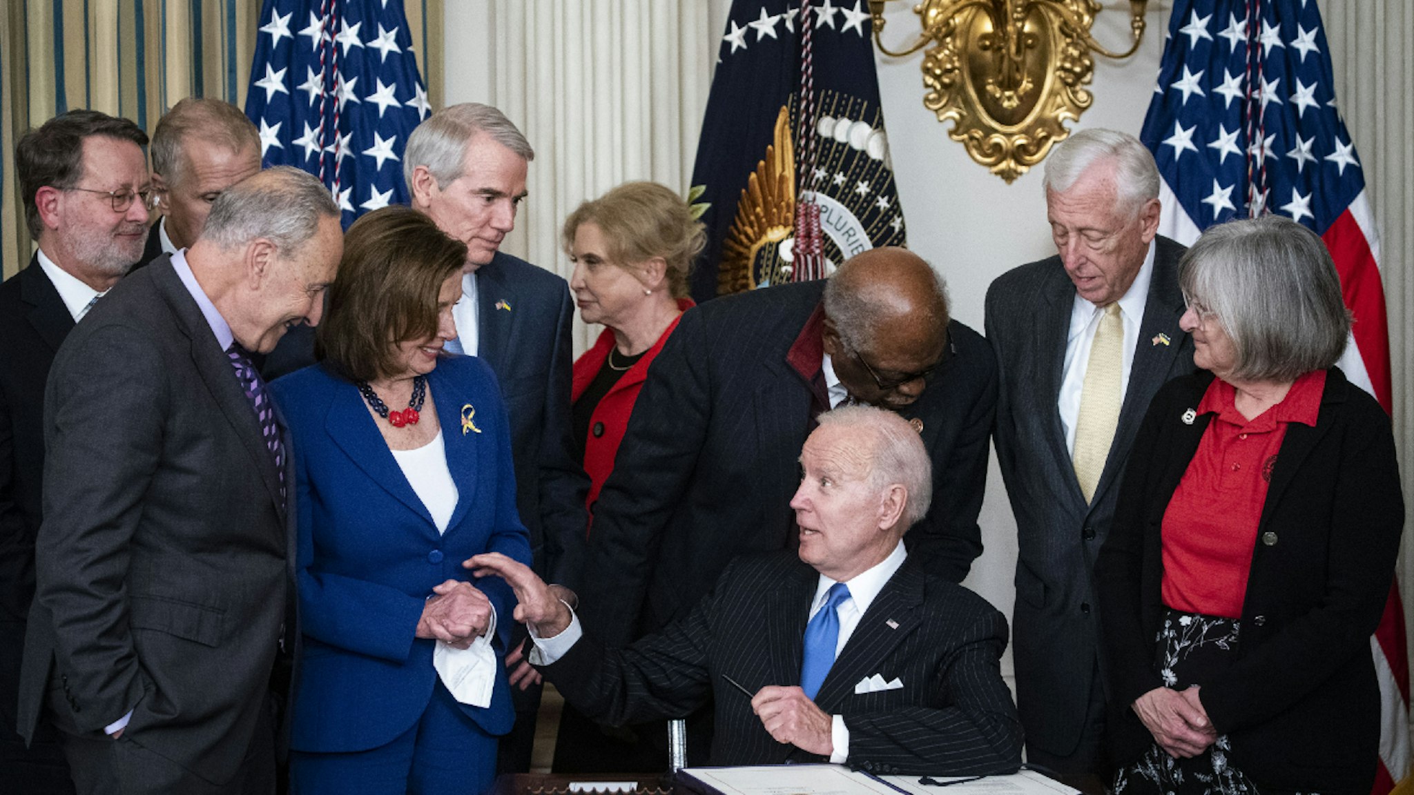 U.S. President Joe Biden speaks with U.S. House Speaker Nancy Pelosi, a Democrat from California, and Senate Majority Leader Chuck Schumer, a Democrat from New York, before signing H.R. 3076, the Postal Service Reform Act of 2022, in the State Dining Room of the White House in Washington, D.C., U.S., on Wednesday, April 6, 2022.
