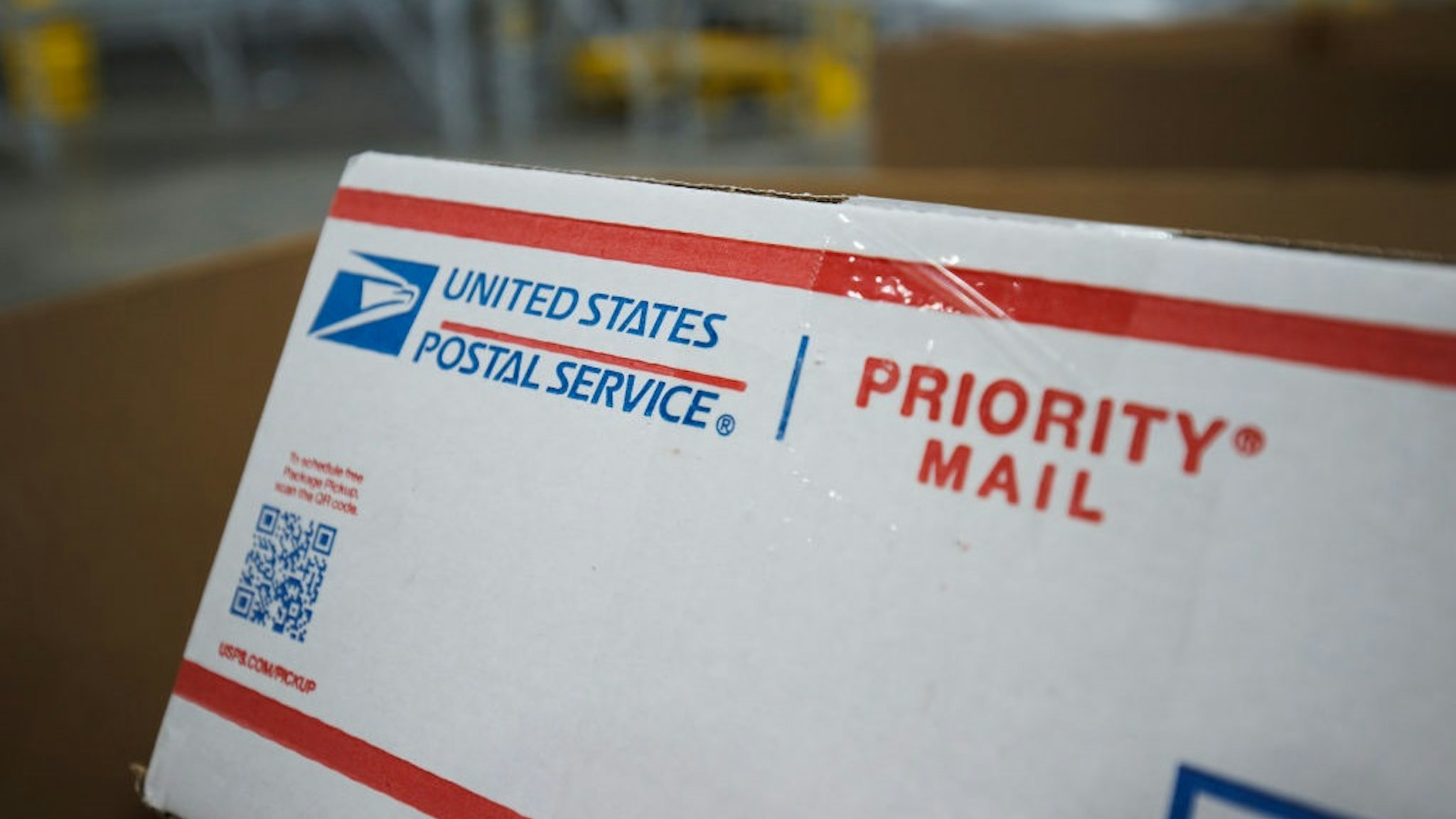 LA VERGNE, TN - NOVEMBER 04: Detail view of the USPS logo on a piece of priority mail packaging during a media tour of a United States Postal Service package support annex on November 4, 2021 in La Vergne, Tennessee.