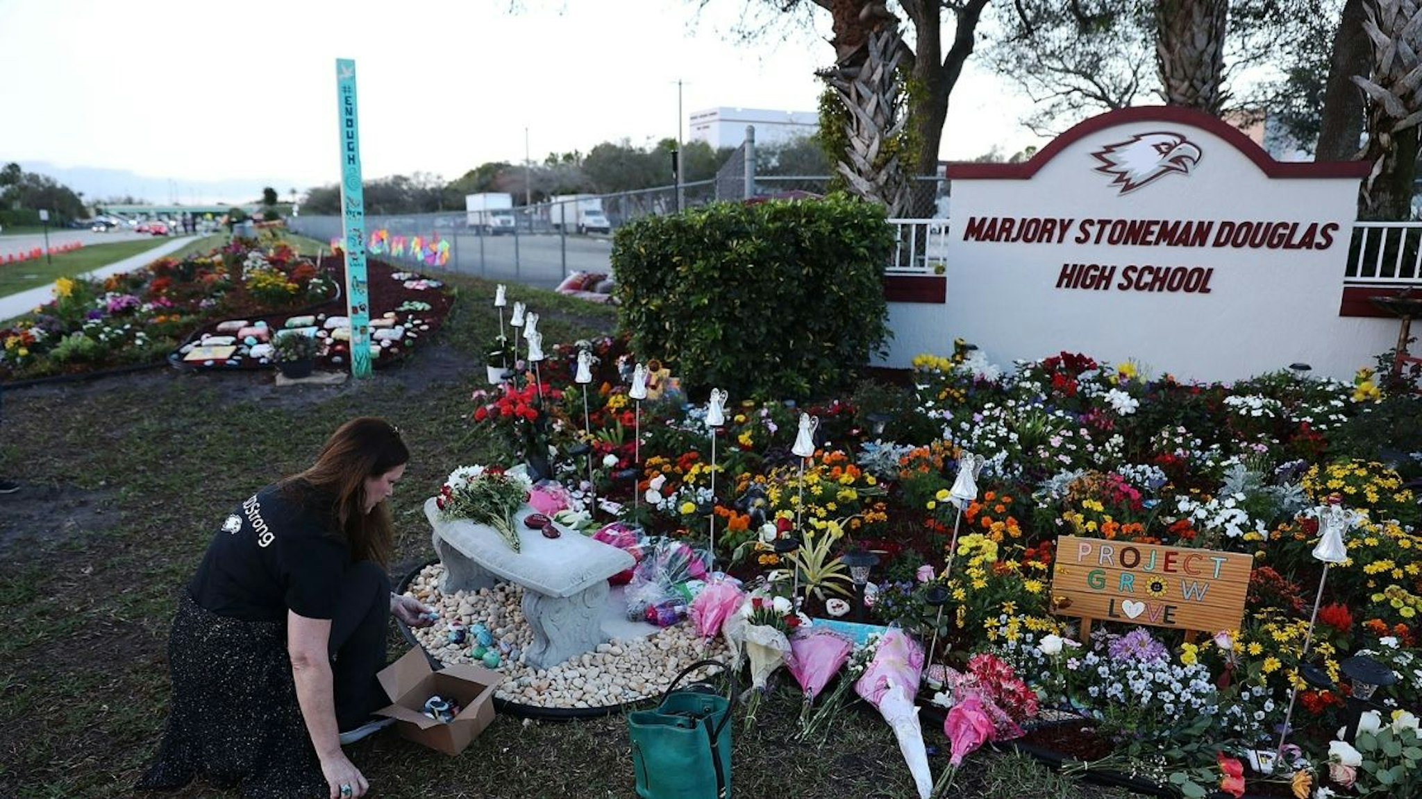 Suzanne Devine Clark visits a memorial setup at Marjory Stoneman Douglas High School for those killed during a mass shooting on February 14, 2019 in Parkland, Florida.