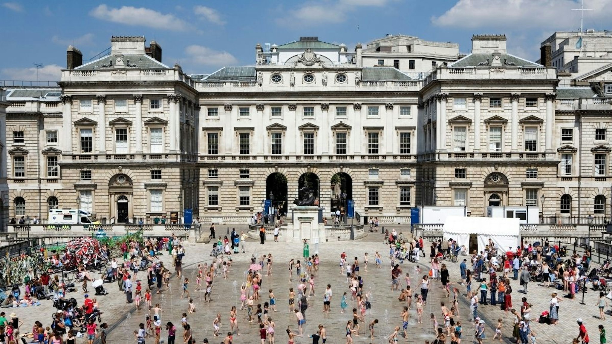 Children play amidst the dancing fountains of the Edmond J. Safra Fountain Court in the Somerset House courtyard.