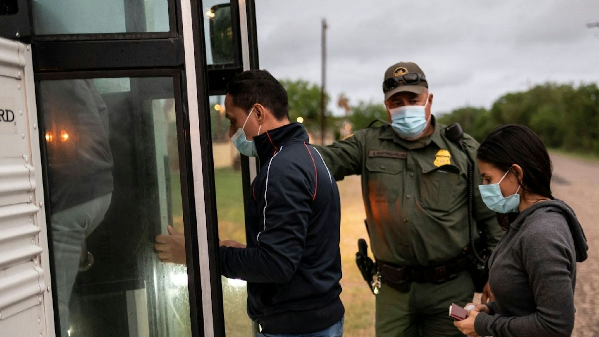 Migrants make their onto a bus after being apprehended near the border between Mexico and the United States in Del Rio, Texas on May 16, 2021.