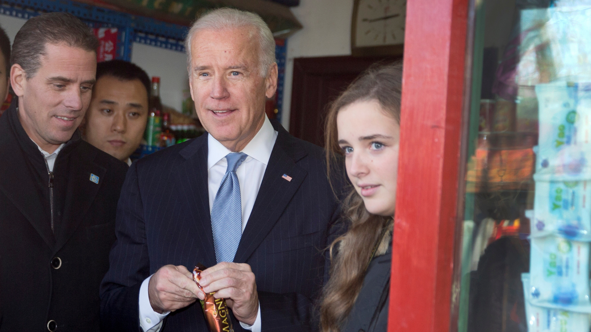 BEIJING, CHINA - DECEMBER 05: U.S. Vice President Joe Biden, center, buys an ice-cream at a shop as he tours a Hutong alley with his granddaughter Finnegan Biden, right, and son Hunter Biden, left on December 5, 2013 in Beijing, China. U.S Vice President Joe Biden is on an official visit to China from December 4 to 5.