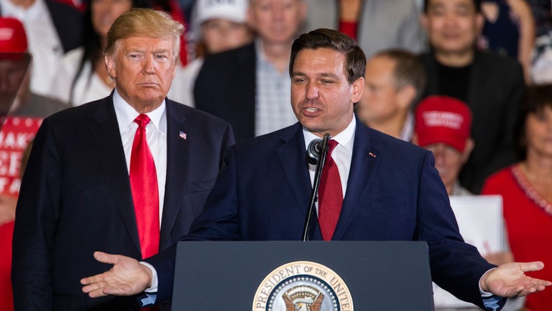 PENSACOLA, FL - NOVEMBER 03: Florida Republican gubernatorial candidate Ron DeSantis speaks with U.S. President Donald Trump at a campaign rally at the Pensacola International Airport on November 3, 2018 in Pensacola, Florida. President Trump is campaigning in support of Republican candidates in the upcoming midterm elections. (Photo by
